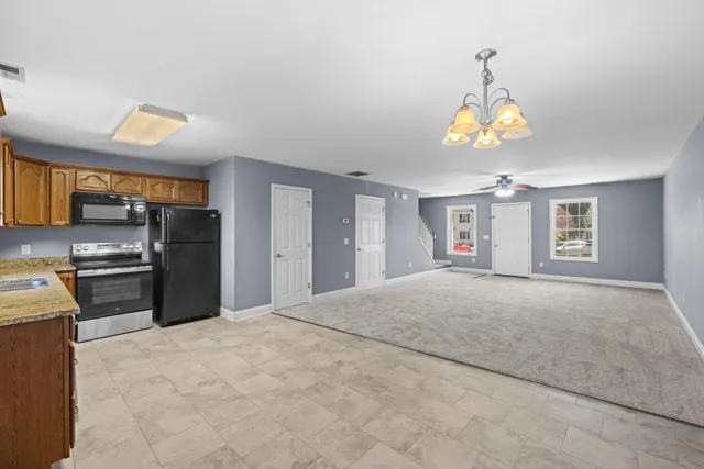 a view of a kitchen with a sink stove and refrigerator