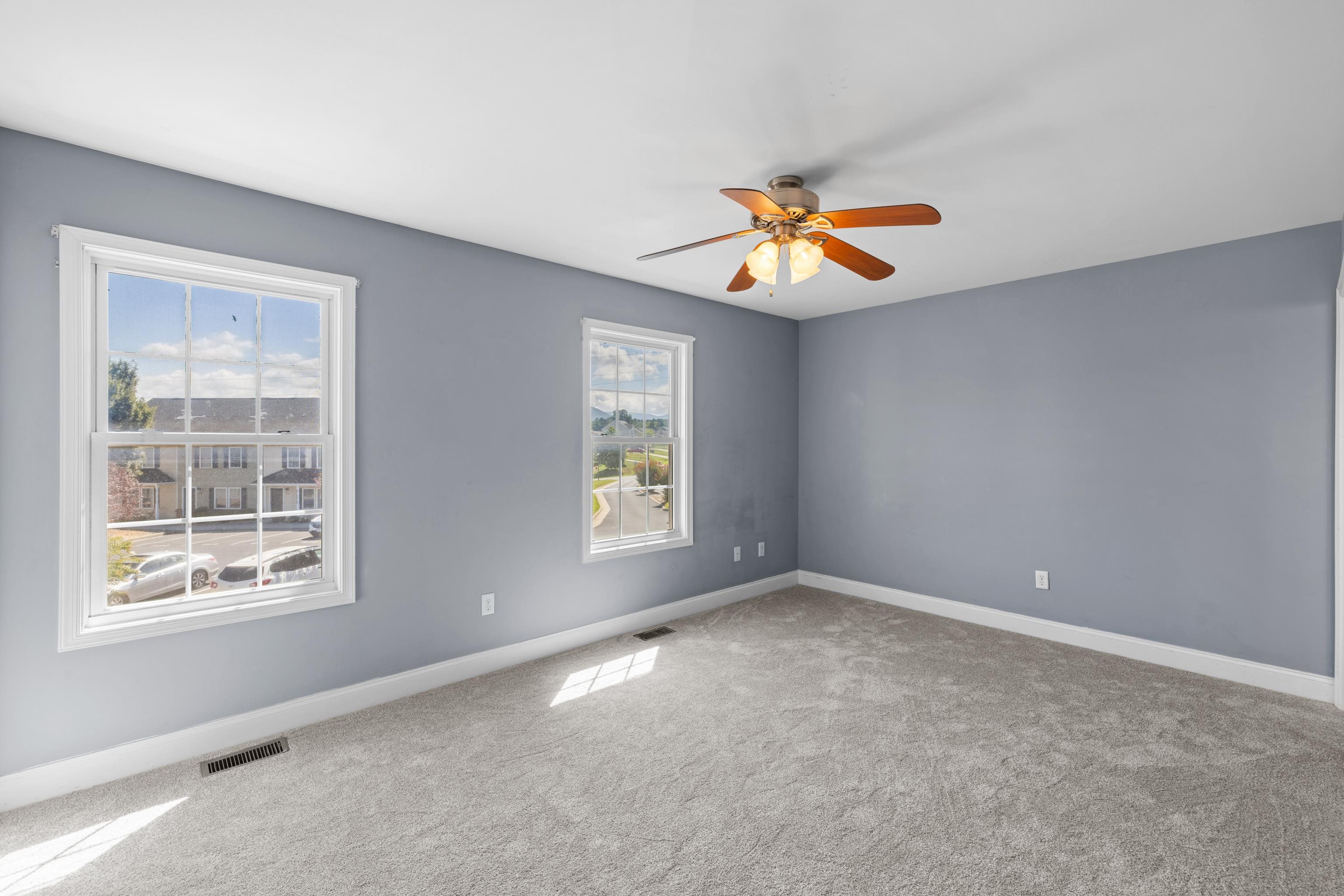 805 Carson Circle Grottoes, VA 24441 - Photo 23 of 40 an empty room with windows and chandelier fan