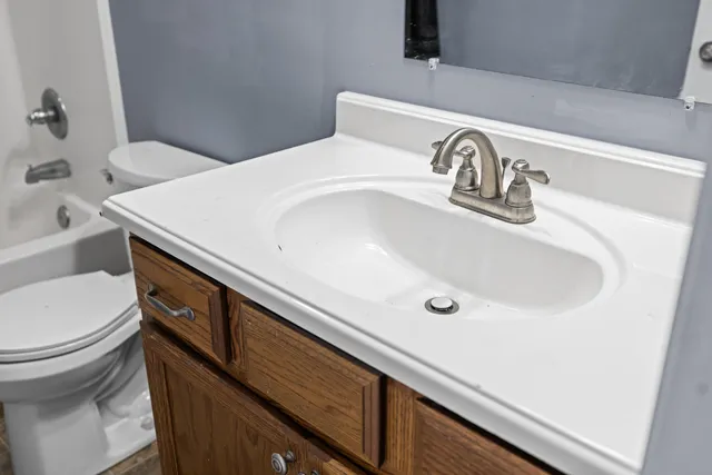 a bathroom with a sink and toilet