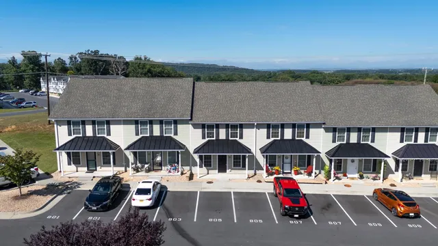 an aerial view of a house with swimming pool and sitting area