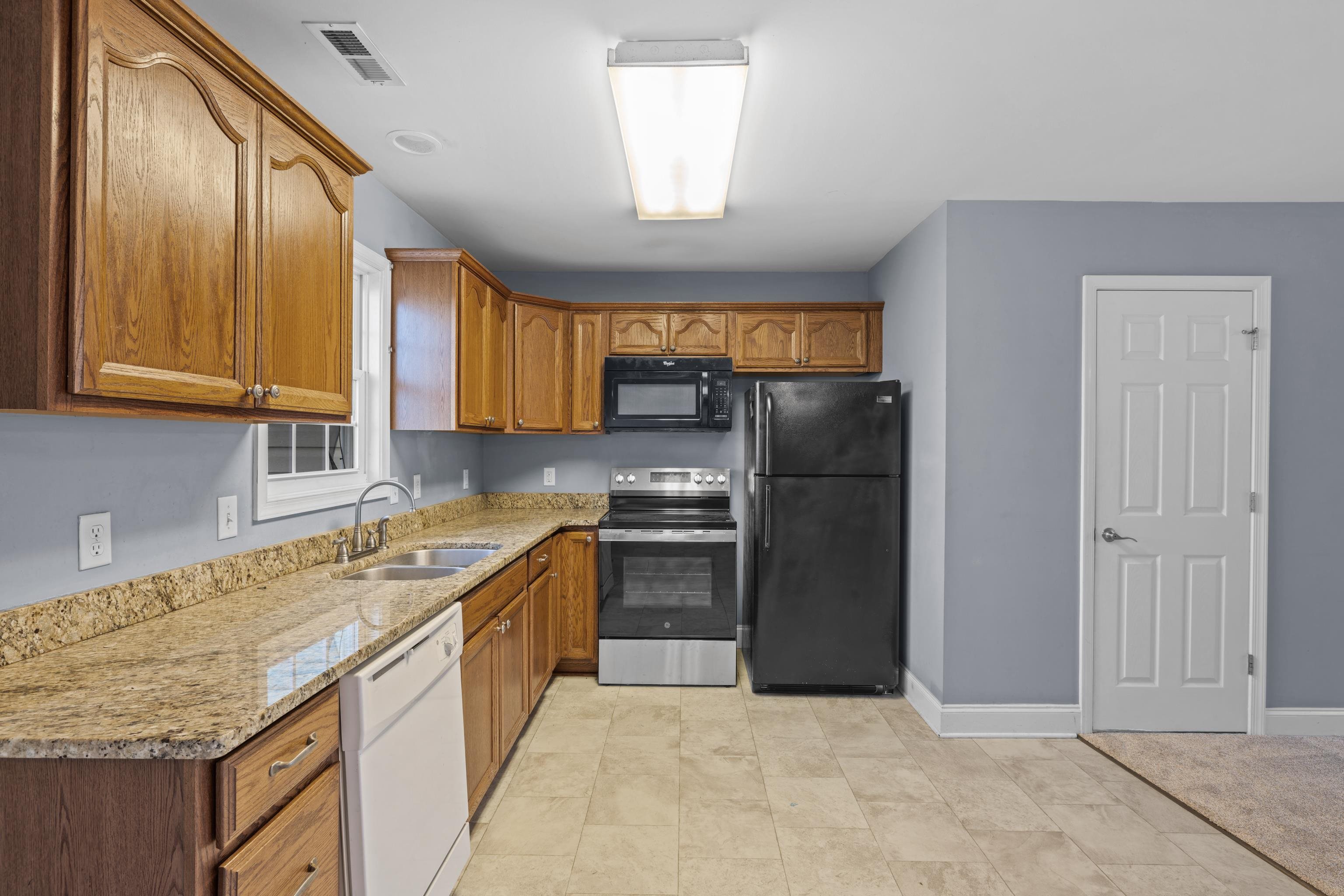 805 Carson Circle Grottoes, VA 24441 - Photo 9 of 40 a kitchen with stainless steel appliances granite countertop a refrigerator and a sink