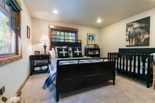 a living room with furniture a piano and a bookshelf