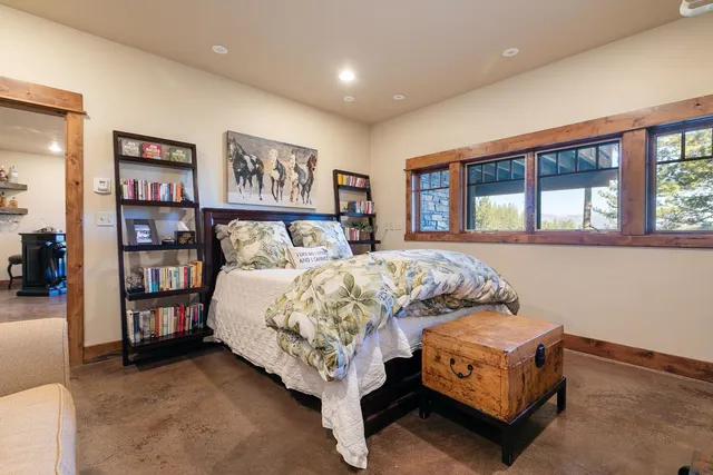 a bed sitting in a bedroom next to a large window