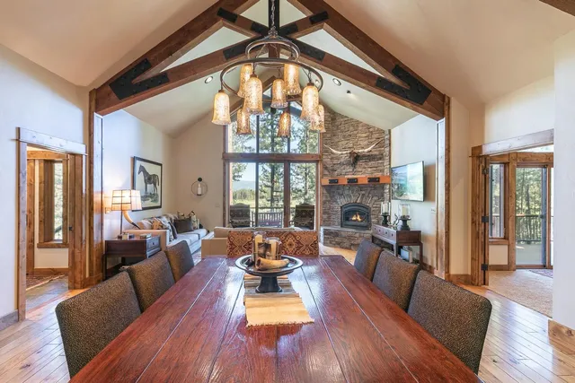 a living room with furniture a large window and wooden floor
