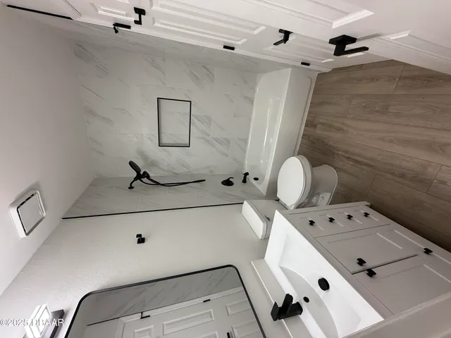 a bathroom with a bathtub sink and mirror