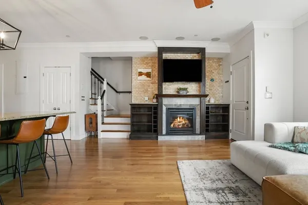 a living room with furniture a flat screen tv and a fireplace