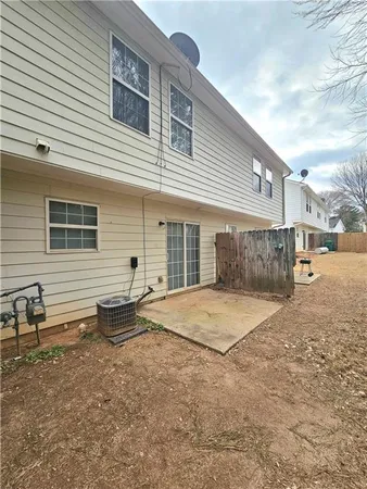 a backyard of a house with barbeque oven and outdoor seating