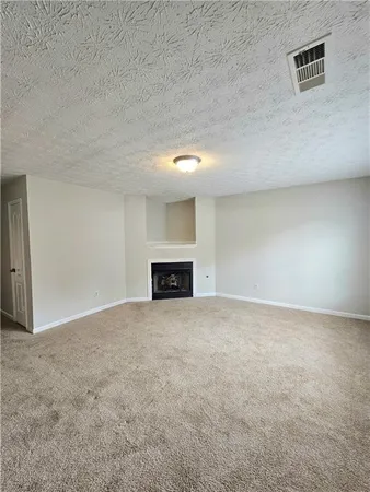 a view of empty room with a fireplace