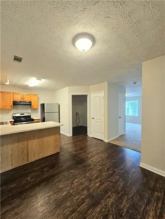 a view of a kitchen with wooden floor and a sink