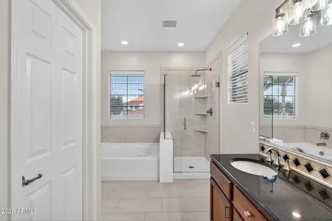 a white bath tub sitting next to a shower