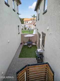 a view of a white house next to a yard