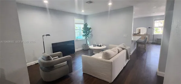 a living room with furniture and a potted plant