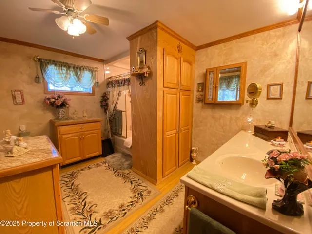 a bathroom with a sink mirror vanity and toilet