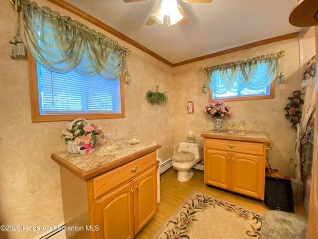 a bathroom with a granite countertop sink a mirror and a shower