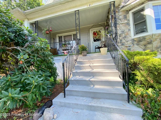a front view of a house with outdoor seating