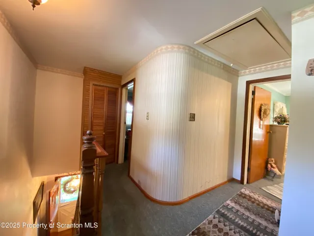 a bedroom with two beds and a chandelier