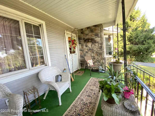 a view of backyard with seating space and hardwood floor