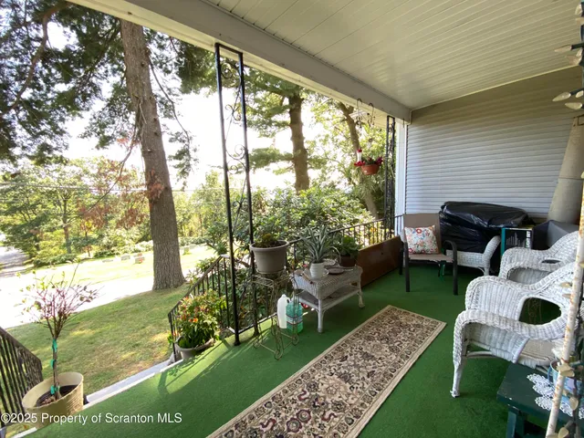 a living room with furniture a fireplace and a table