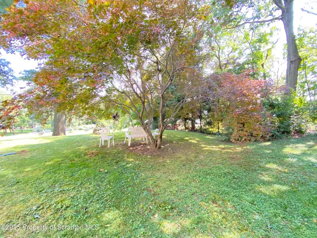 a view of a house with a yard and garage