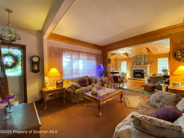 a living room with furniture fireplace and a large window