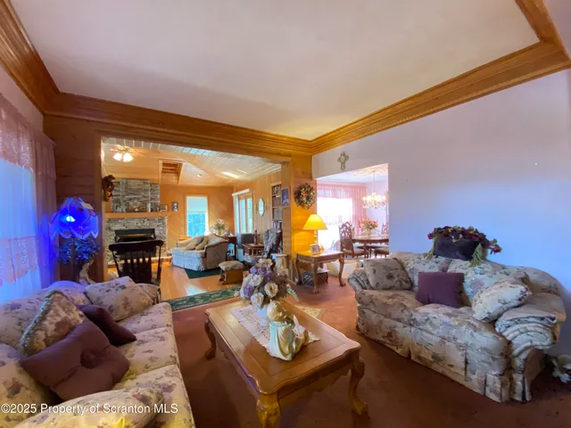 a view of a dining room with furniture and chandelier