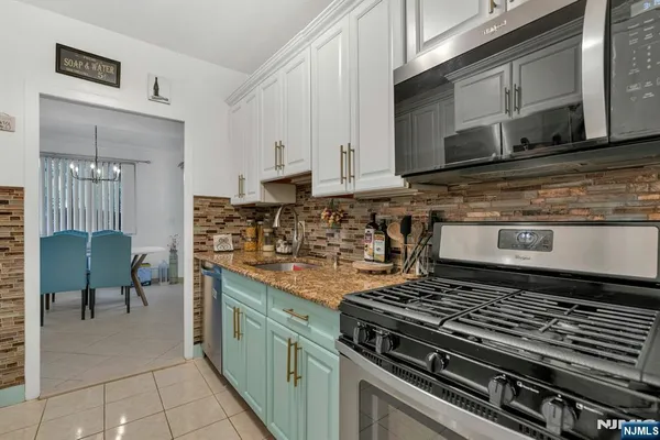 a kitchen with stainless steel appliances granite countertop a stove and a microwave