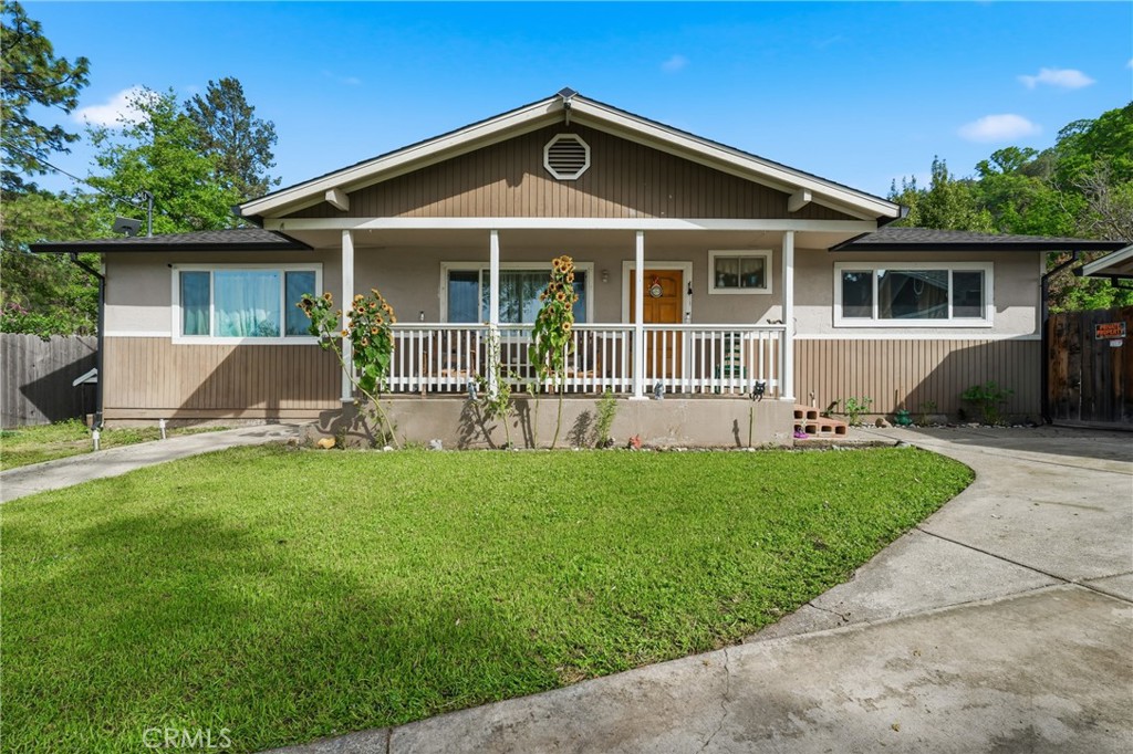 6802 Doris Circle Lucerne, CA 95458 - Photo 1 of 1 a front view of a house with a yard and porch