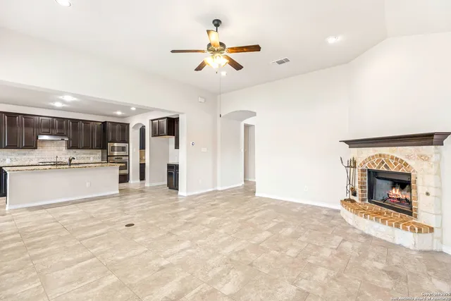 a view of an empty room with a fireplace