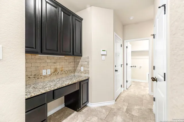 a large kitchen with stainless steel appliances granite countertop a sink stove and refrigerator