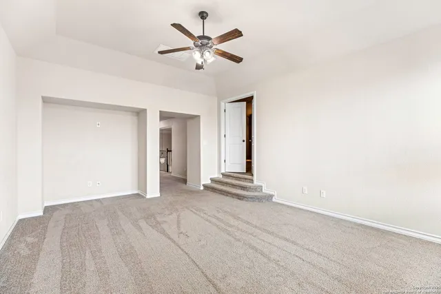 a view of a room with a ceiling fan