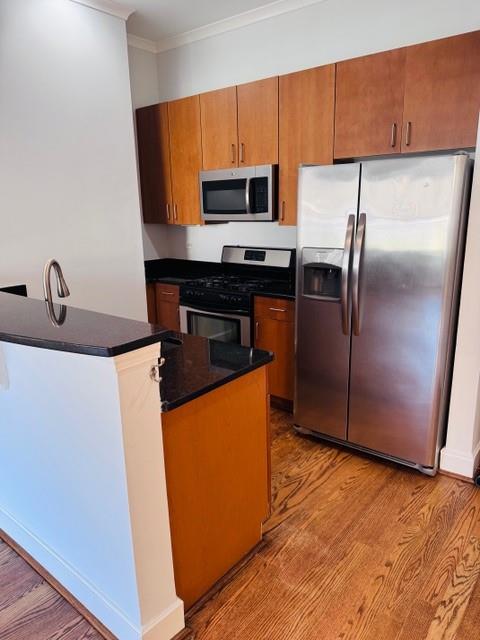 384 Ralph McGill Boulevard Northeast, Unit 121 Atlanta, GA 30312 - Photo 20 of 38 a kitchen with granite countertop a refrigerator and a sink