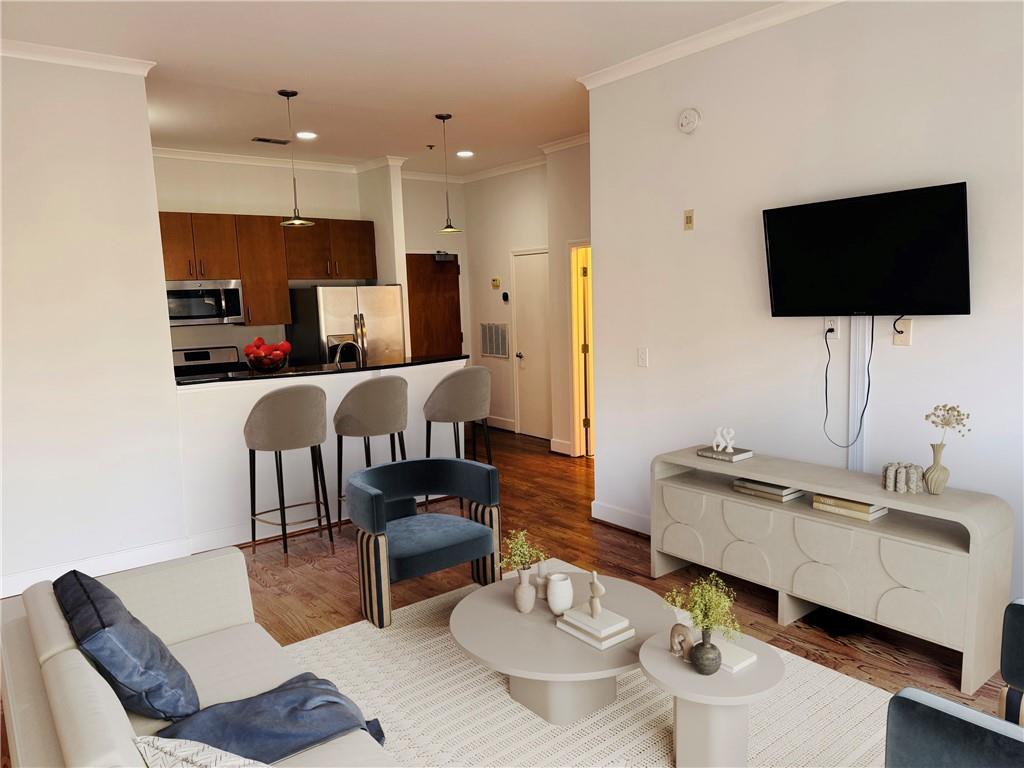 384 Ralph McGill Boulevard Northeast, Unit 121 Atlanta, GA 30312 - Photo 2 of 38 a living room with furniture and a flat screen tv