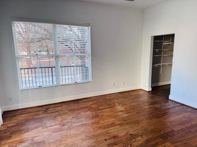 384 Ralph McGill Boulevard Northeast, Unit 121 Atlanta, GA 30312 - Photo 22 of 38 a view of an empty room with wooden floor and a window