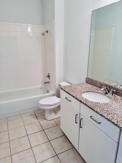 384 Ralph McGill Boulevard Northeast, Unit 121 Atlanta, GA 30312 - Photo 26 of 38 a bathroom with a granite countertop sink a toilet and a bathtub