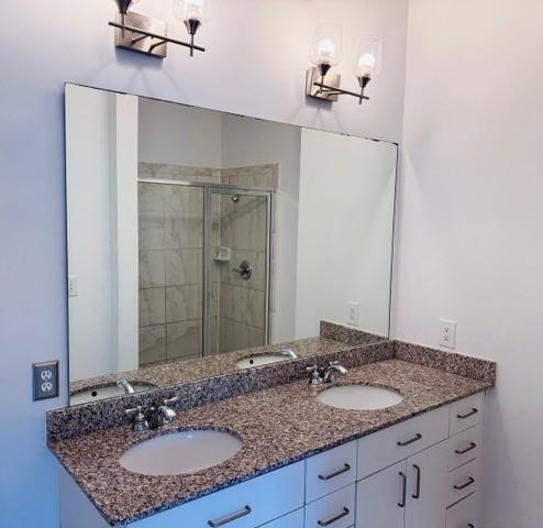 384 Ralph McGill Boulevard Northeast, Unit 121 Atlanta, GA 30312 - Photo 28 of 38 a bathroom with a granite countertop sink and a mirror