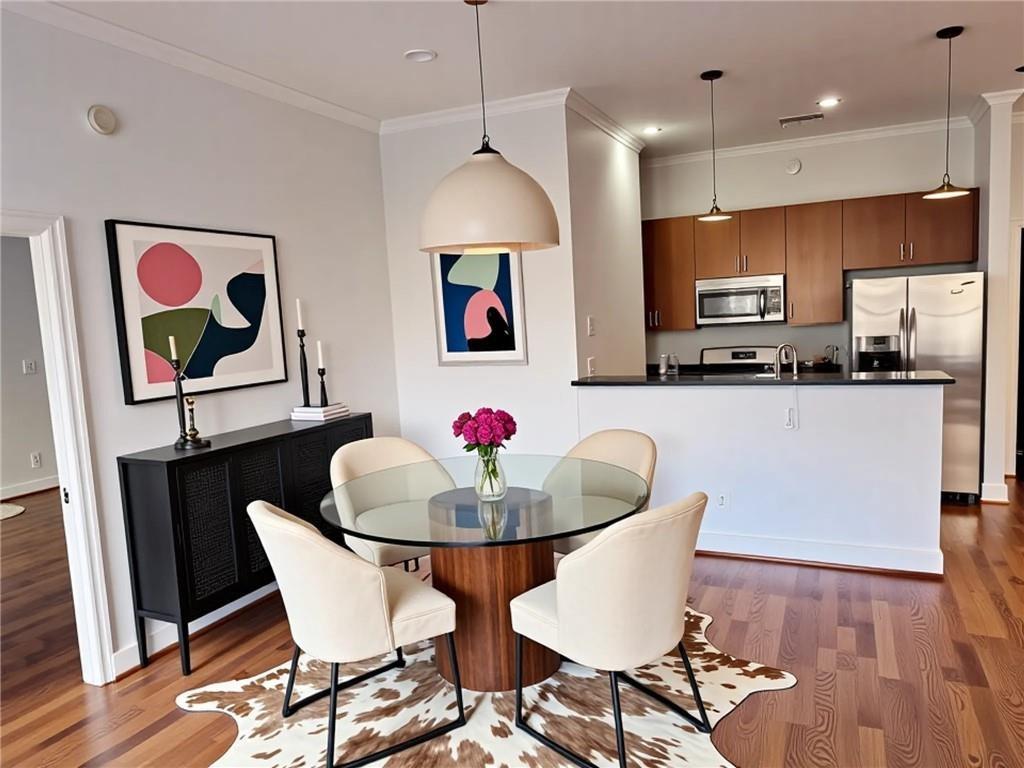 384 Ralph McGill Boulevard Northeast, Unit 121 Atlanta, GA 30312 - Photo 3 of 38 a dining room with furniture and wooden floor