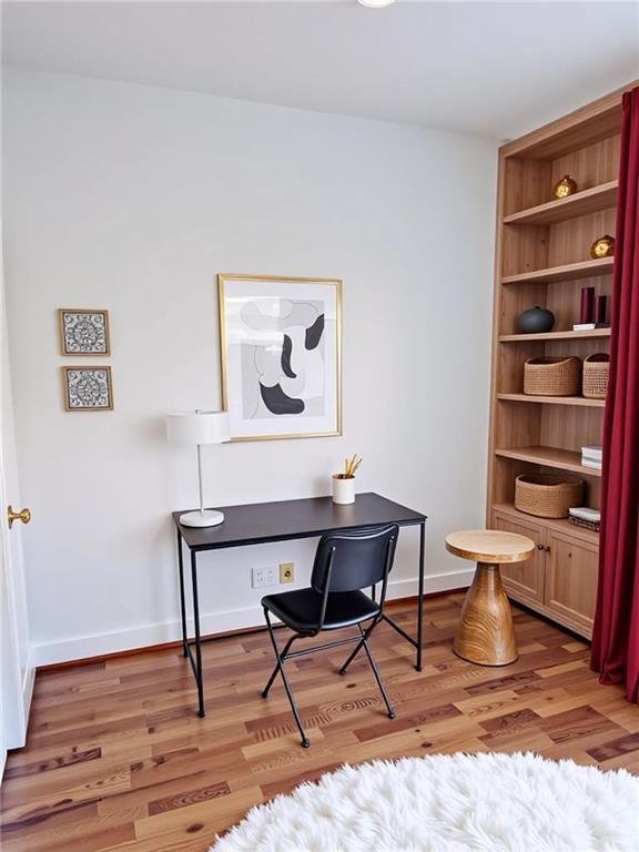 384 Ralph McGill Boulevard Northeast, Unit 121 Atlanta, GA 30312 - Photo 5 of 38 a workspace with furniture and wooden floor