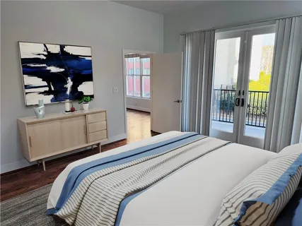 a bedroom with a large bed and a window