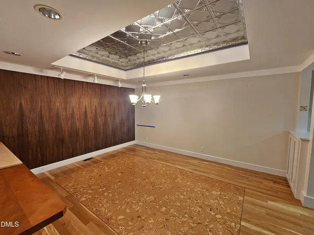 a view of a kitchen with stainless steel appliances granite countertop a stove and cabinets