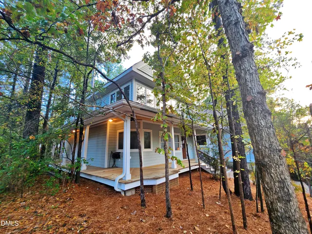 a view of a house with backyard porch and sitting area