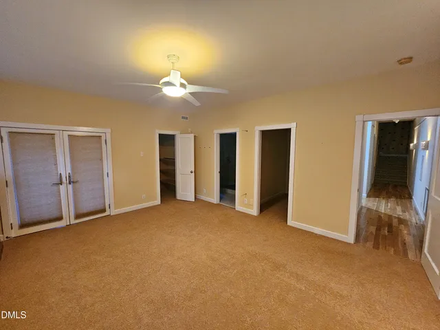 a view of an empty room with a kitchen