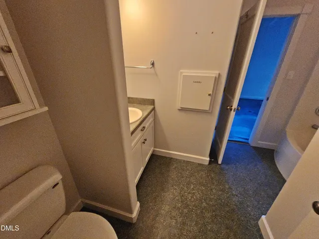 a spacious bathroom with a tub sink and mirror
