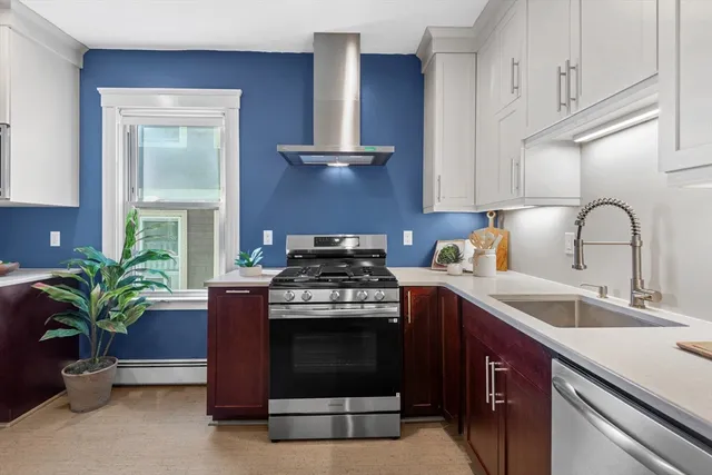 a kitchen with a sink stove and cabinets