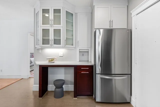 a kitchen with stainless steel appliances a refrigerator and cabinets