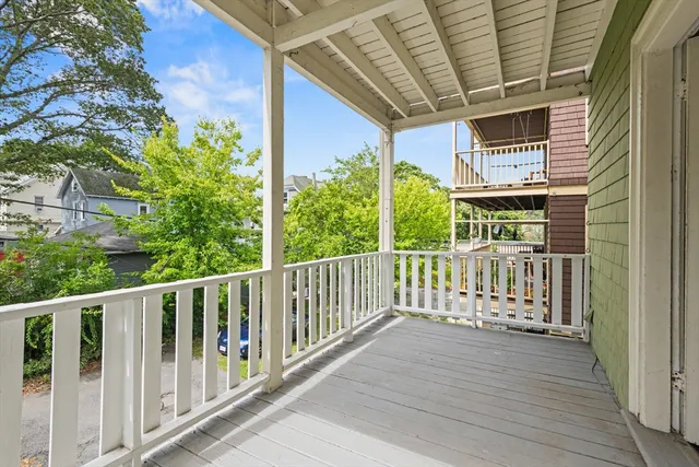 a view of a balcony with wooden floor