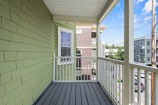a view of a balcony with wooden floor