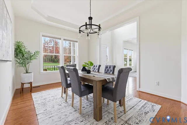 a living room with furniture a large window and a fireplace