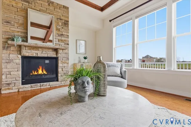 a kitchen with stainless steel appliances granite countertop a refrigerator a stove a kitchen island with chairs and wooden floor