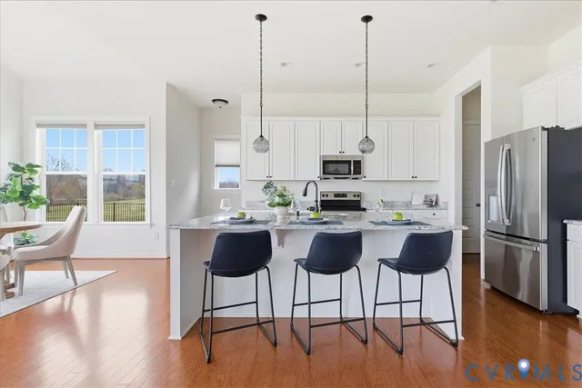 a dining room with furniture window and wooden floor