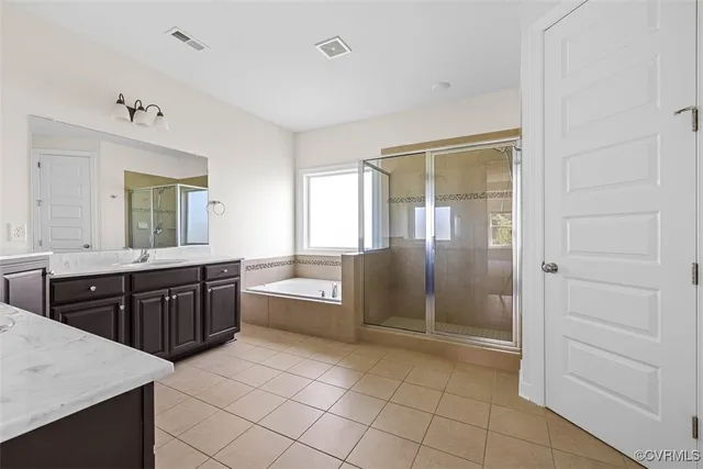 a bathroom with a granite countertop sink a toilet and shower